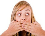 Closeup of young women covering her mouth with both hands